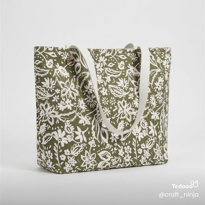 Sage green botanical patterned tote bag with white leathers handles.
